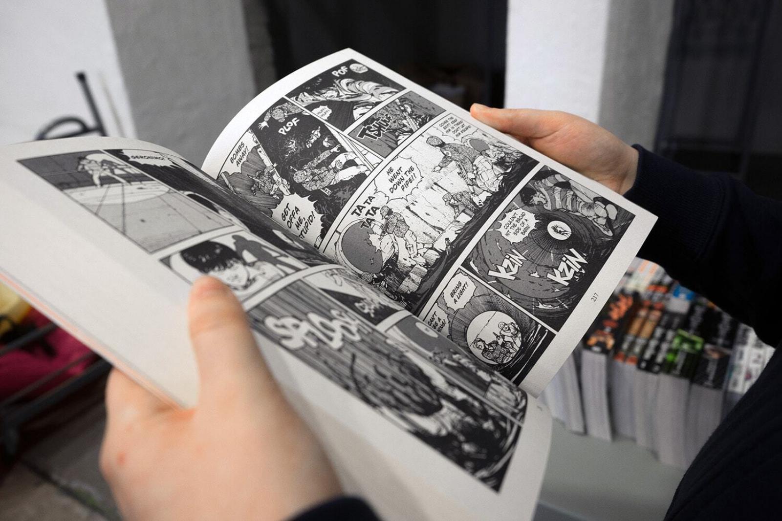 Person holding open a comic book